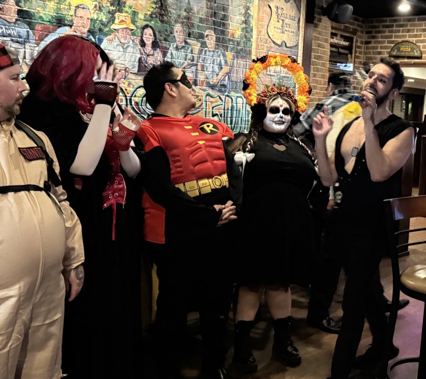 A group in costumes enjoying a karaoke theme night